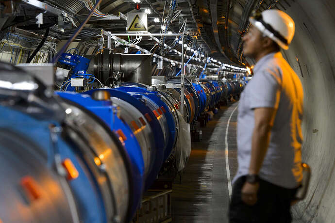 A scientist looks at a section of the Large Hadron Collider at the European Organisation for Nuclear Research (CERN) in Switzerland, July 2013. Scientists have detected signs of neutrinos in the collider.