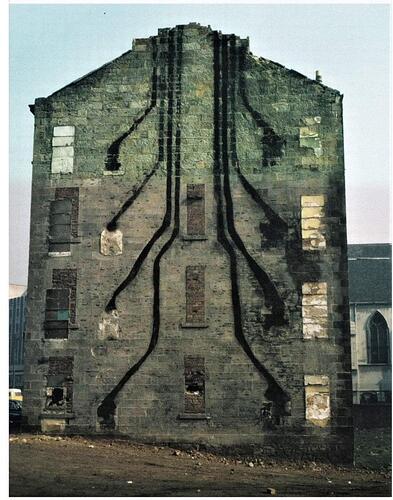 A Glasgow building during demolition (1972), showing soot trails to chimneys