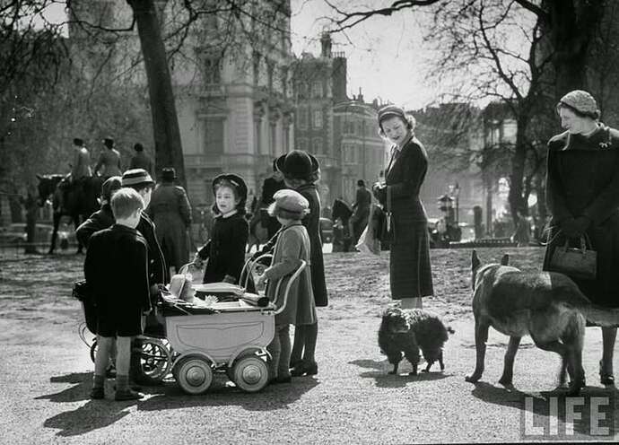 Children playing and people walking their pets in the Hyde Park in London on a lovely Spring 1951 history
