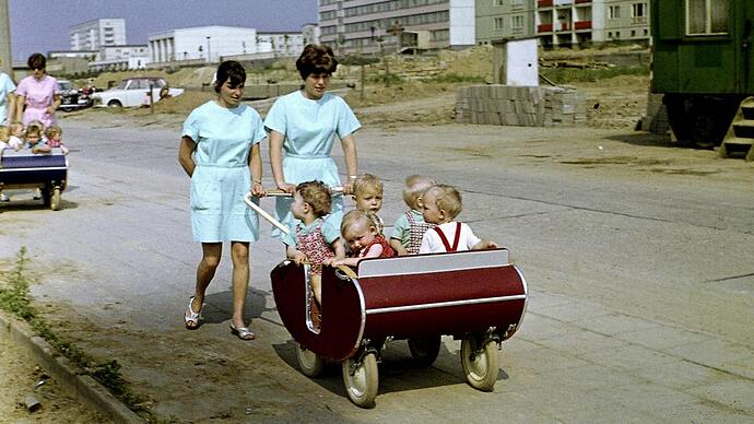 Kindergarten teachers strolling the children in East Berlin during the 1950s, on Rosenfelder Ring in the Lichtenberg district.
