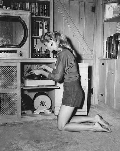 A lady shows her HiFi tube record player, 1952