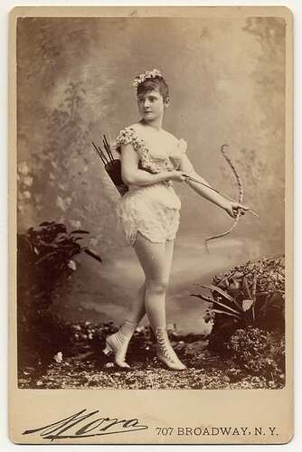This is a Cabinet Card Photo of a NYC Actress dressed as Cupid & identified only as Miss Farrington circa 1886