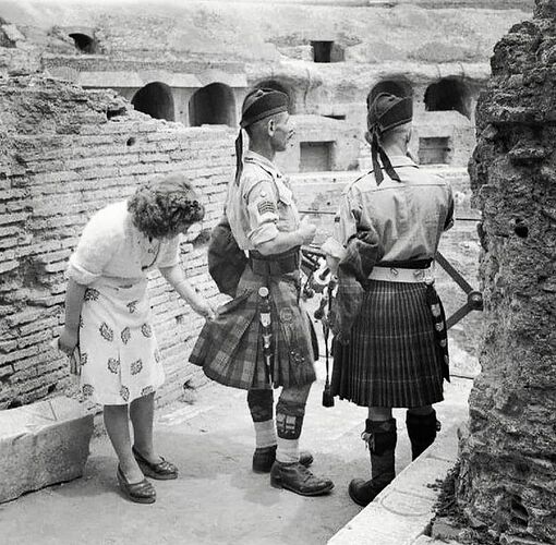This Italian woman curiously inspecting the kilt of a Scottish soldier. Colosseum, Rome in 1944.