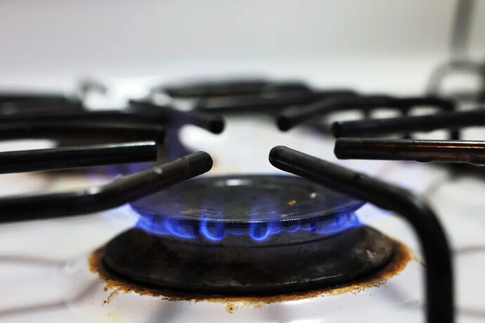 A flame burns on a gas stove.