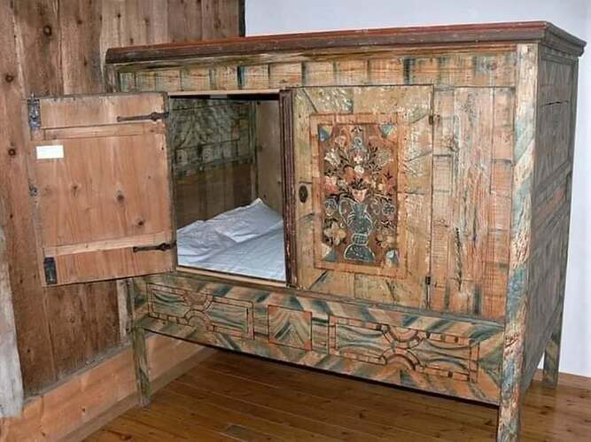 Around 600 years ago this kind of bed, built into a piece of furniture, was very popular, and it is starting to make a comeback today. As its name implies, the box bed is completely contained within a wooden box.