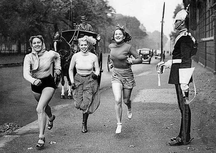 London street scenes Three young women running past a guard – 1937