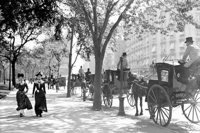 History 1899 2 women stroll by a line of carriages near madison square garden