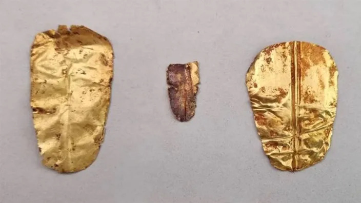 Three gold foil tongues were found buried with the mummies. Egyptian Ministry of Tourism and Antiquities