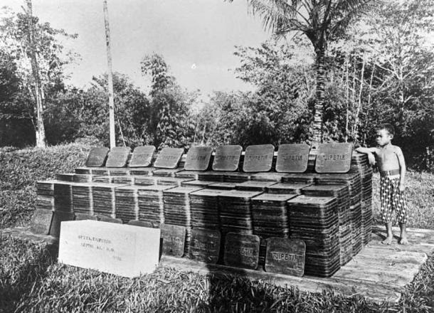 Late-19th-century Indonesian gutta-percha plantation with stacks of rubber-like blocks. (Tropenmuseum / CC BY-SA 3.0)